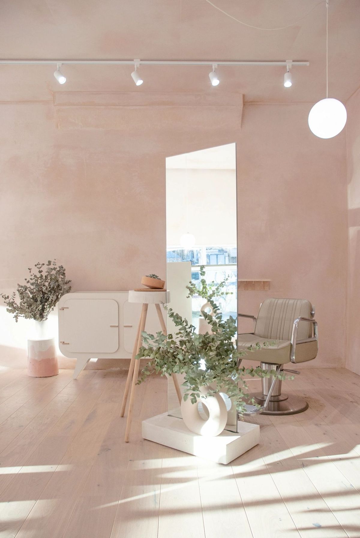 The KOOP Studio styling floor with pale wood floors, plants and soft pink plaster walls